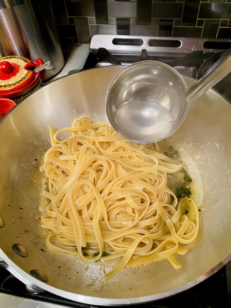 Adding pasta water to pan.