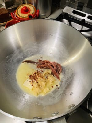 Butter, garlic and anchovies in pan.
