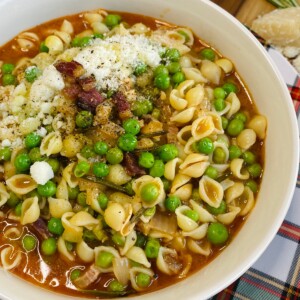 Finished pasta e piselli is styled in bowl.