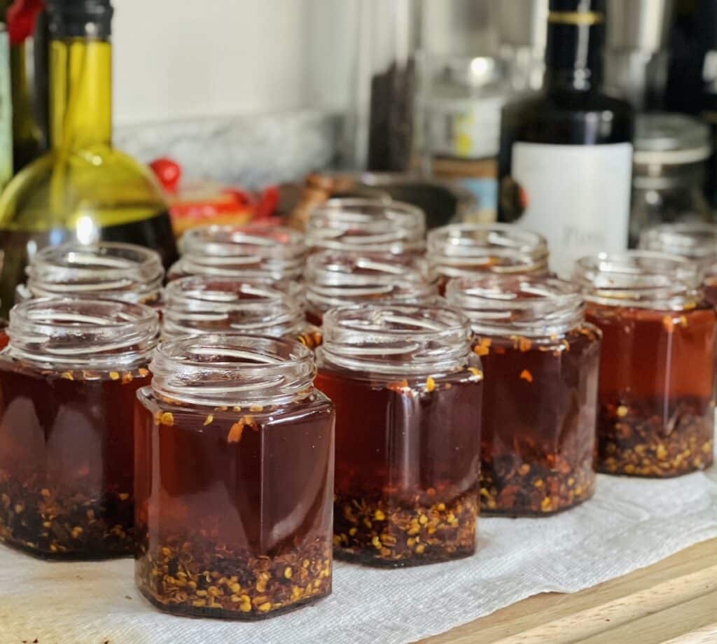 Side view of jars filled with Italian chili oil.