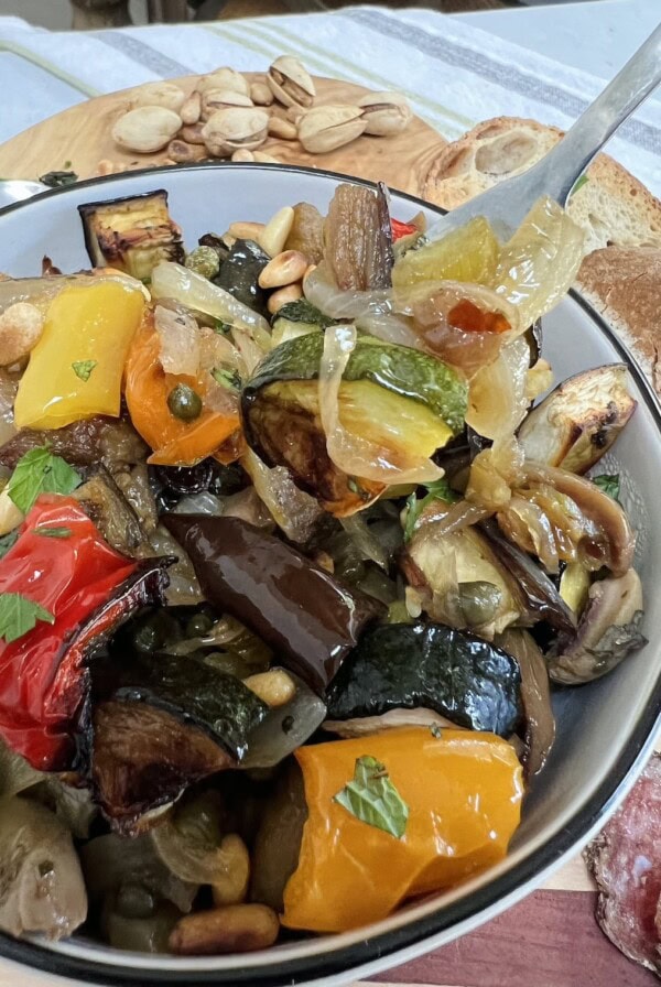 Bowl of vegetable caponata with fork.