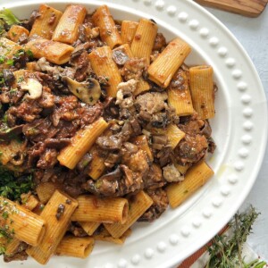 Overhead view of boscaiola pasta in white platter.