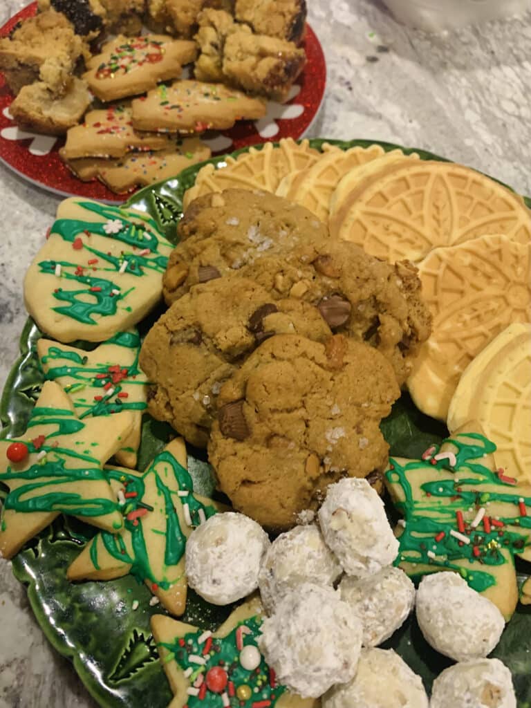 Assorted Christmas cookie platter, containing Buttery Pecan Snowball Cookies, Anise Pizzelles and Peanut Butter Cup Chocolate Chip Cookies.