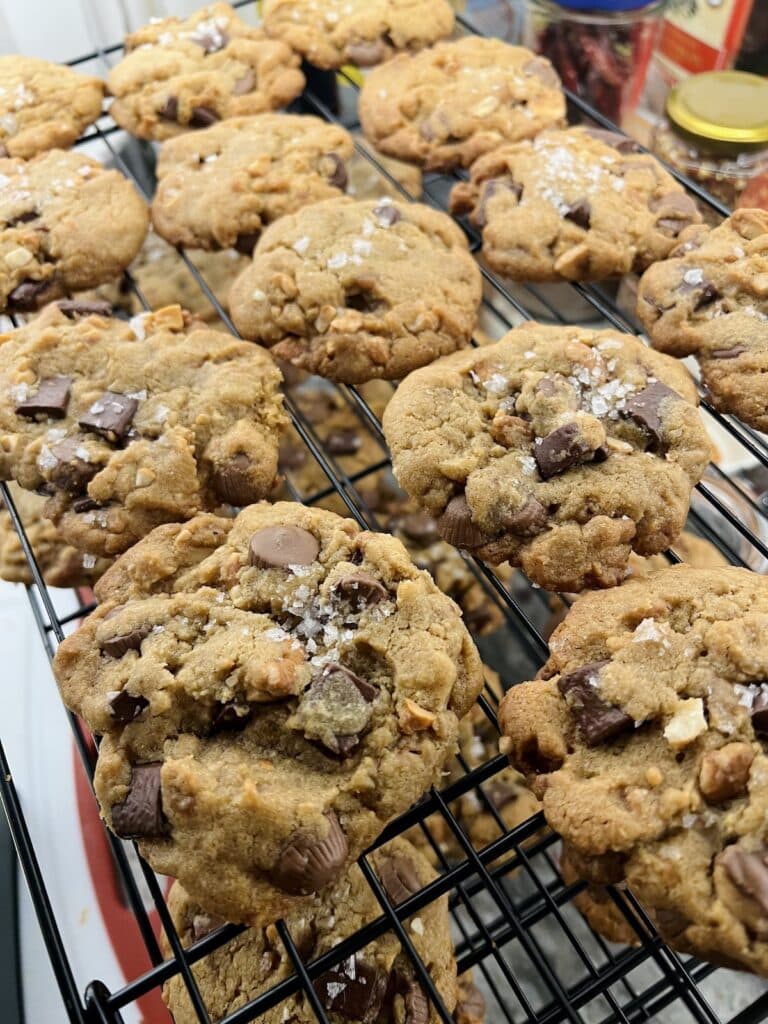 Salted Peanut Butter Cup Chocolate Chip Cookies cooling on wire rack.