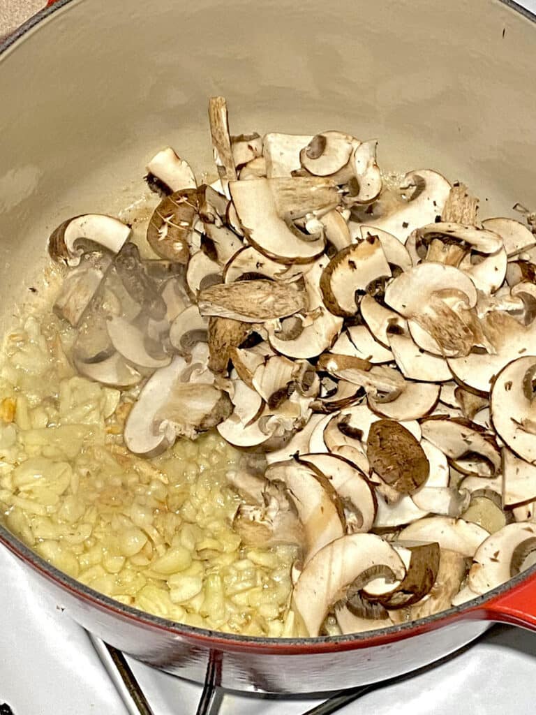 Mushroom and garlic cooking in Dutch oven.