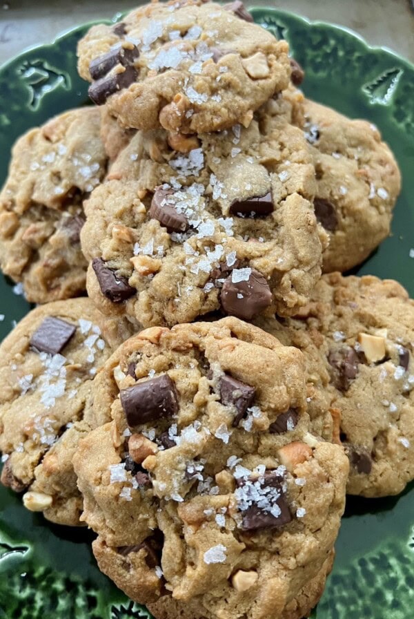 Close up of Peanut Butter Cup Chocolate Chip Cookies with large pieces of flaky sea salt.