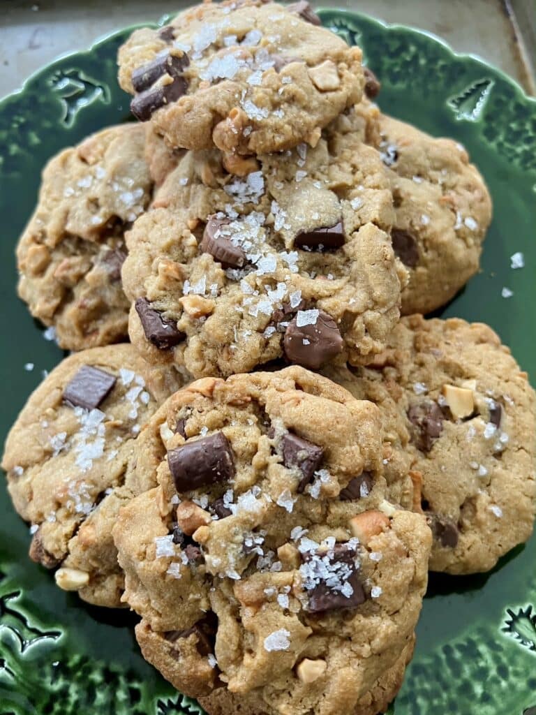 Close up of Peanut Butter Cup Chocolate Chip Cookies with large pieces of flaky sea salt.