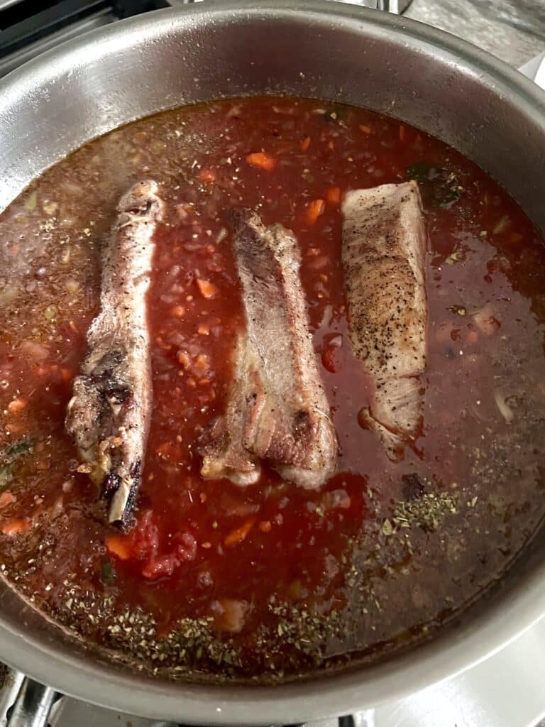 Pork pieces in tomato mixture ready to simmer.