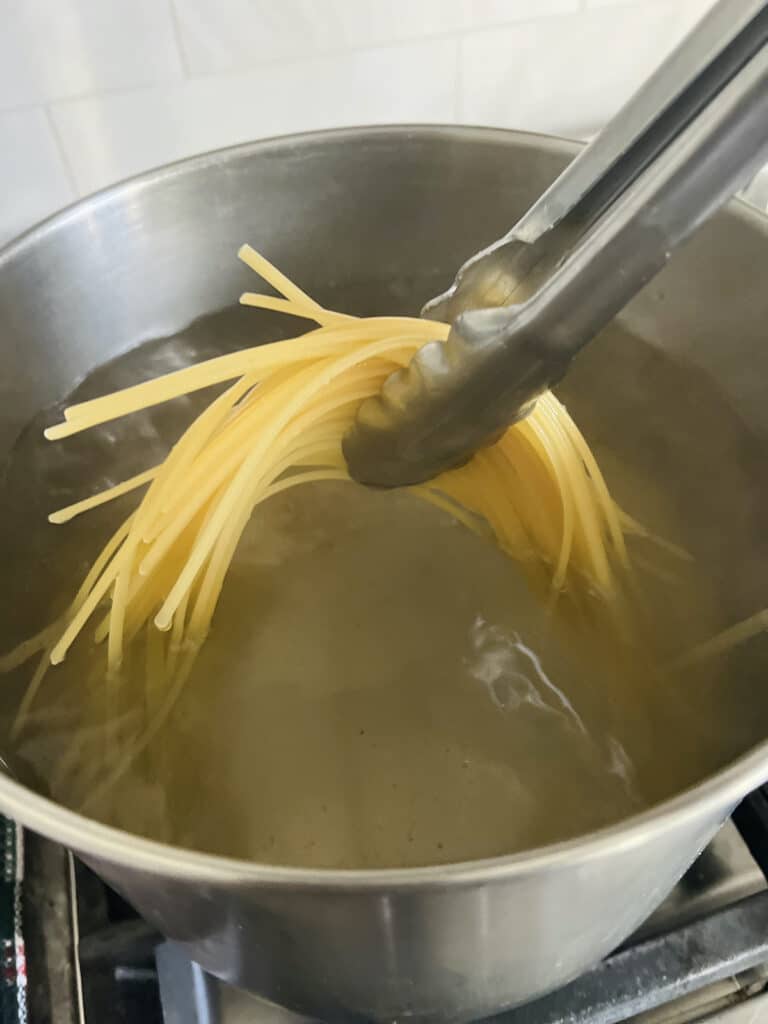 Cooking linguine pasta in salted boiling water.