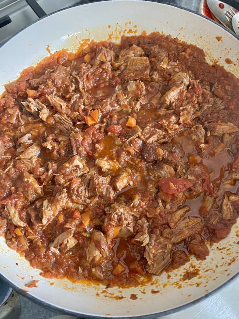 Pork ragu recipe finished and in pan being heated and ready to combine with pasta.