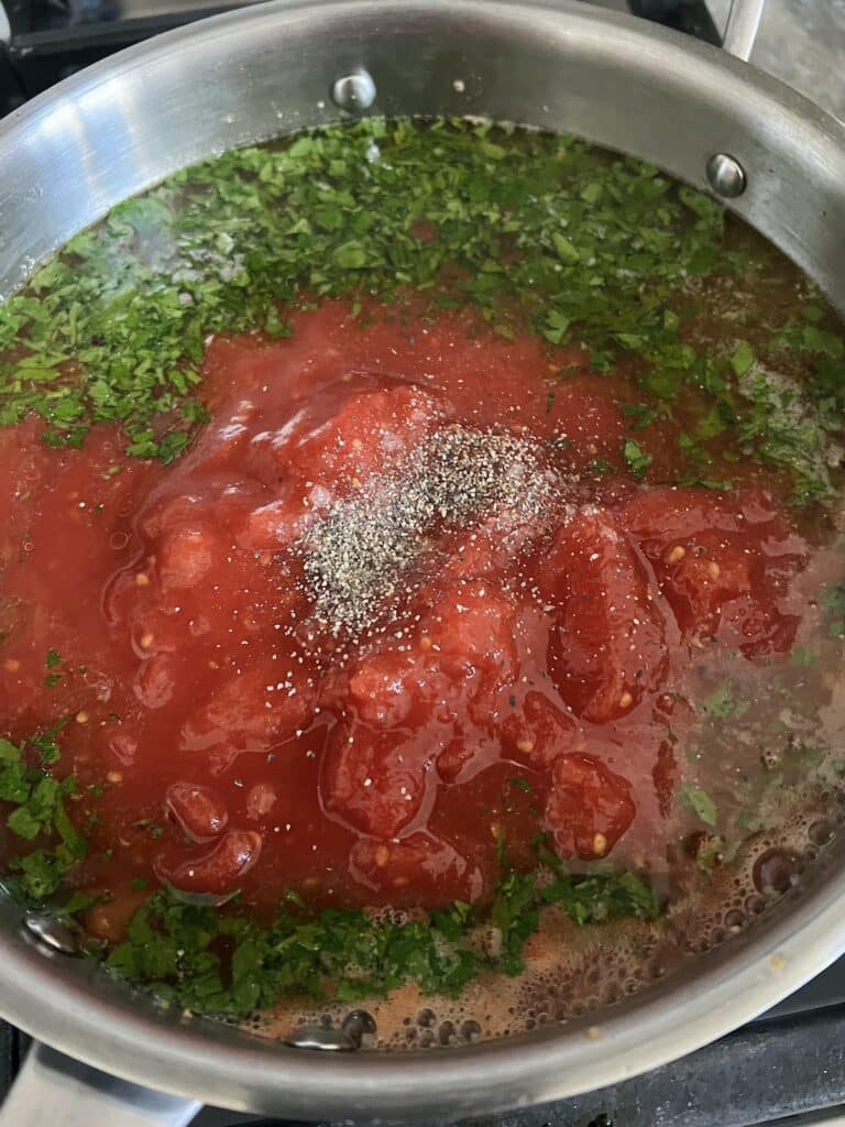 Tomato mixture simmering for red vongole sauce.