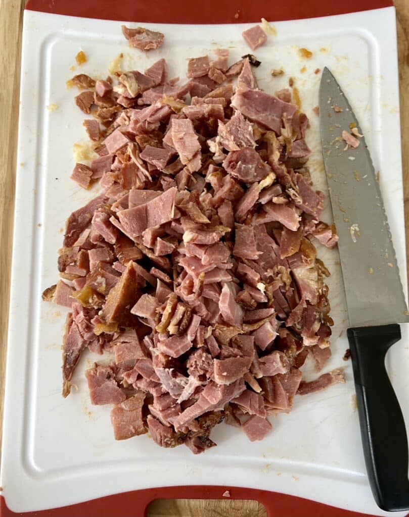 Can you refreeze ham that has been already baked? Photo of leftover ham being diced for packaging in freezer.