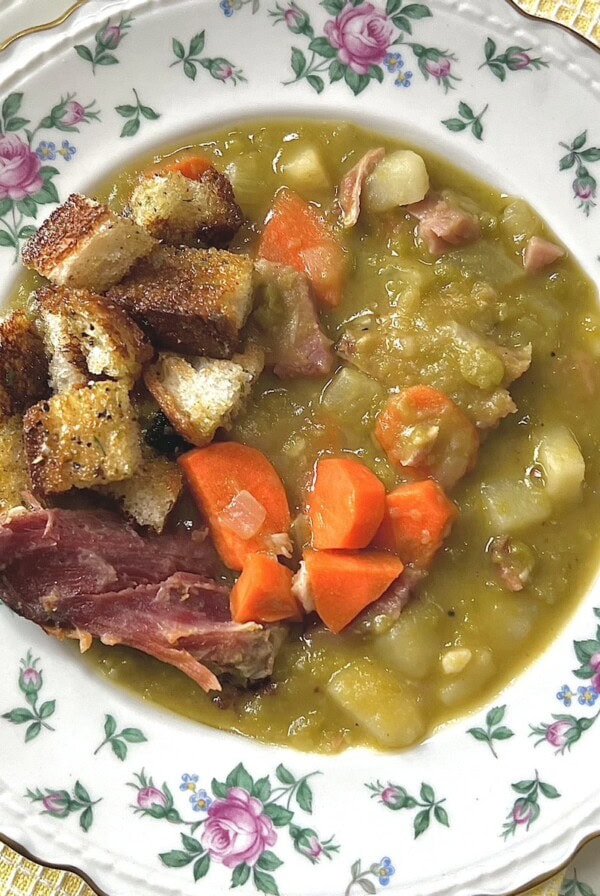 Split Pea and Ham Soup with Potatoes in decorative bowl topped with croutons.