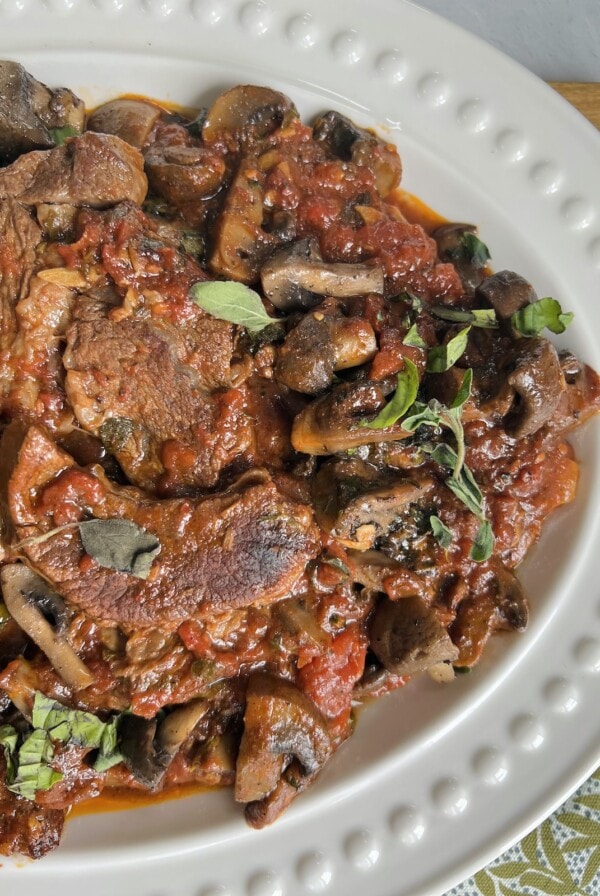Pizzaiola Sauce with Beef in decorative white platter.
