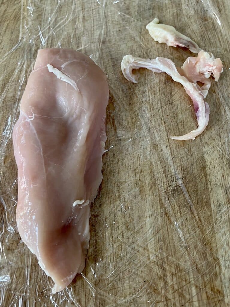 Big pieces of fat removed from chicken breast.