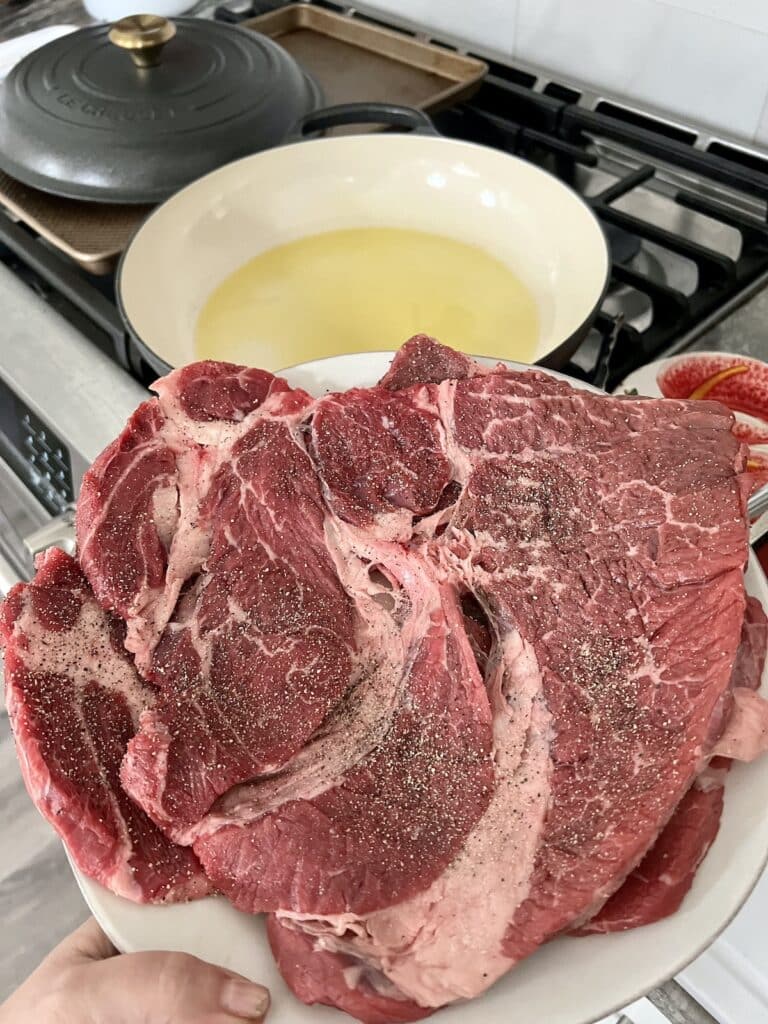 Beef ready to be seared in pan with oil.