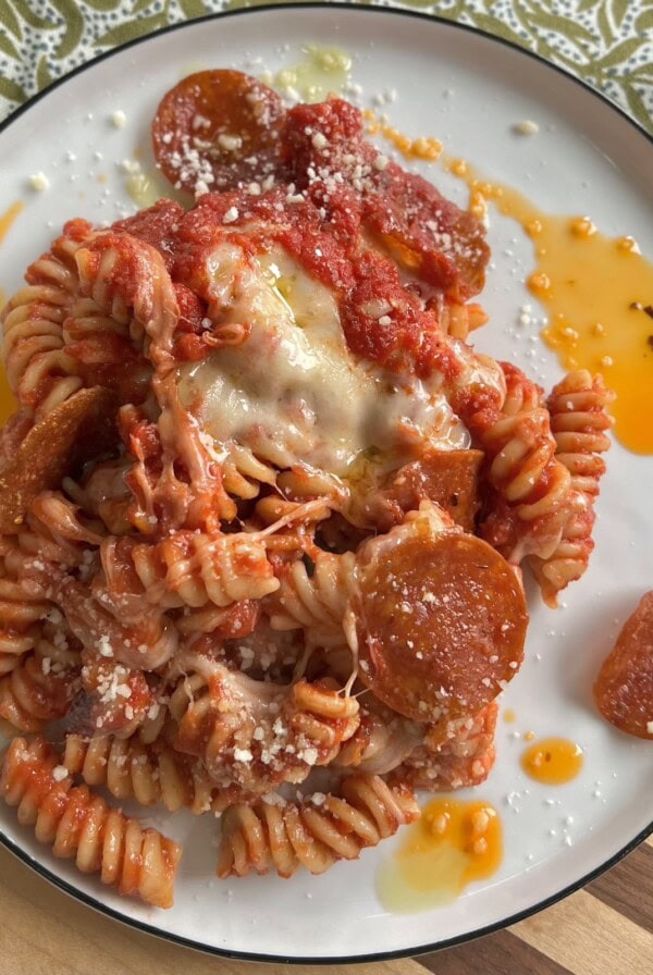 Plated pizzaiolo pasta on white plate with spicy oil.