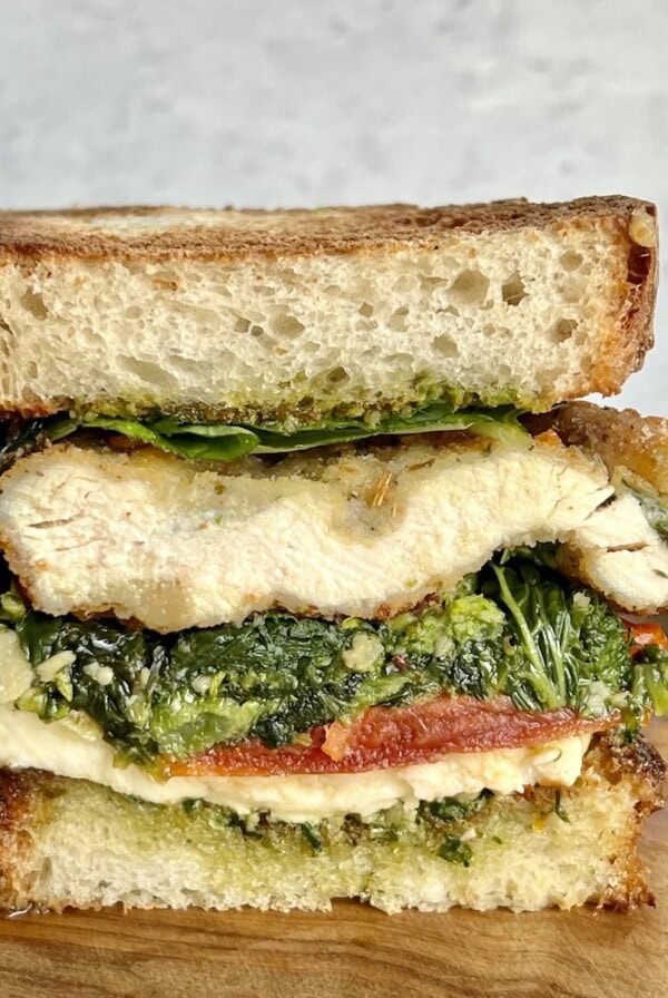 Half chicken cutlet sandwich with broccoli rabe, pesto, fresh basil, fresh mozzarella and roasted tomatoes on toasted Italian bread.