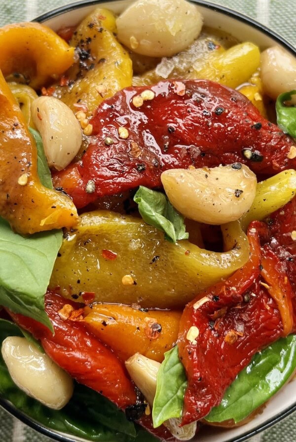 Close up of colorful Italian roasted peppers in white bowl.