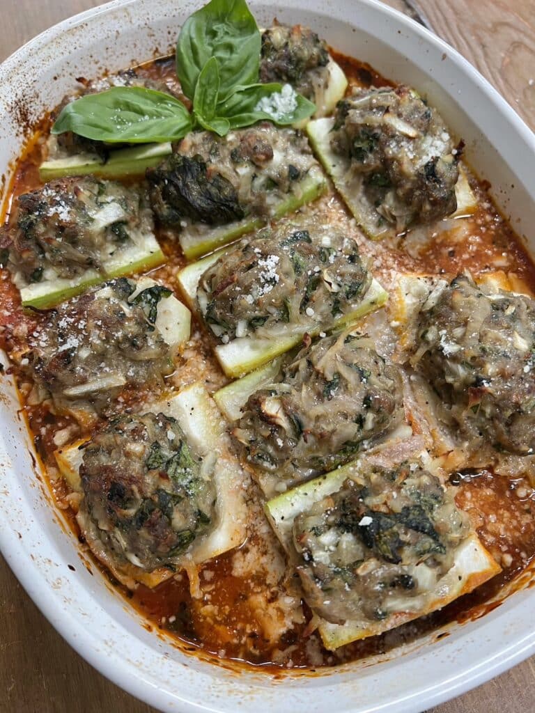 Finished gagootz recipe in white baking dish with basil sprig garnish.