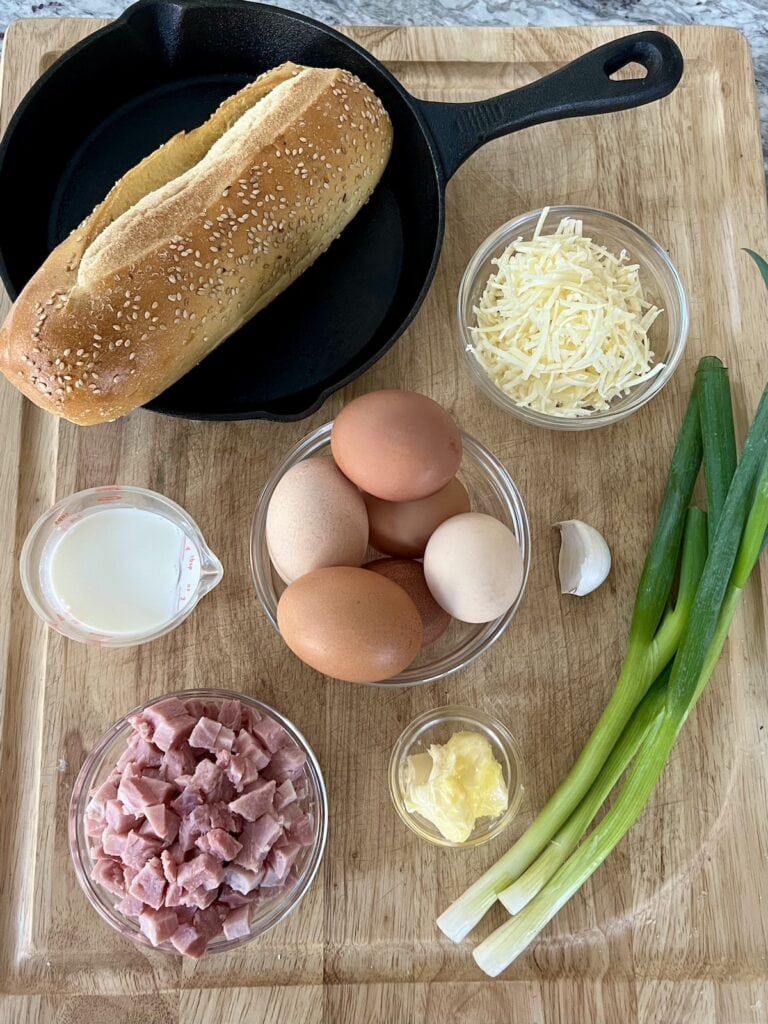 All ingredients for easy ham and cheese frittata on cutting board.