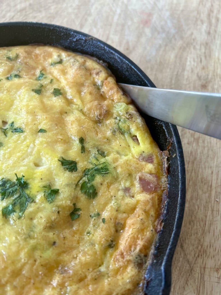 Use a knife to loosen the baked egg from the side of the pan.