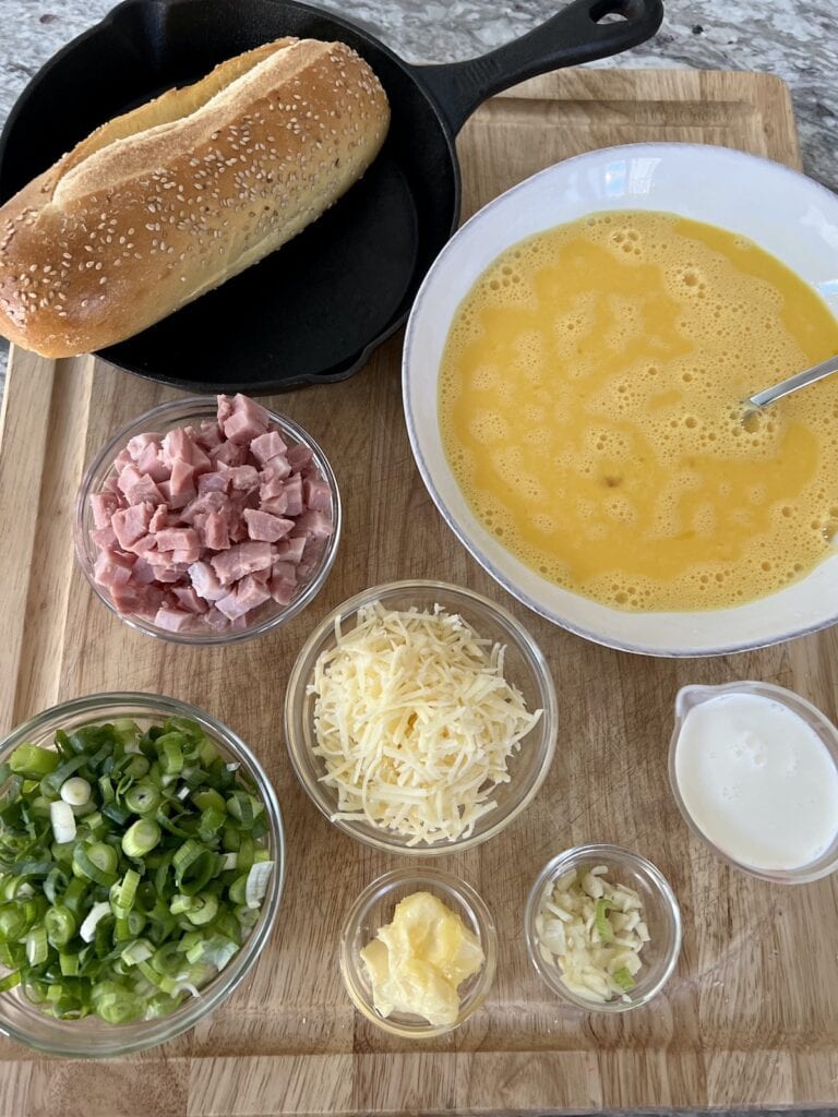 All prepped ingredients for easy ham and cheese frittata on cutting board.