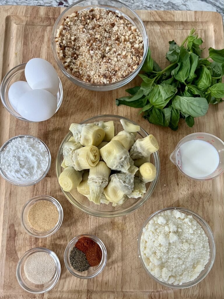 All ingredients for crispy Italian pan fried artichoke hearts on cutting board.