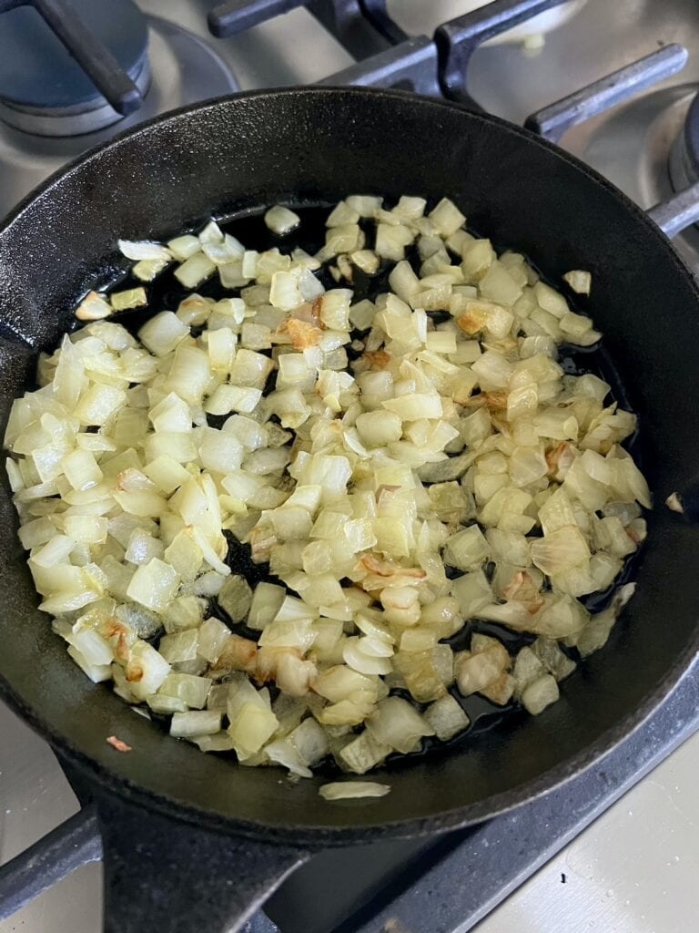 Sautéing onions in cast iron pan.