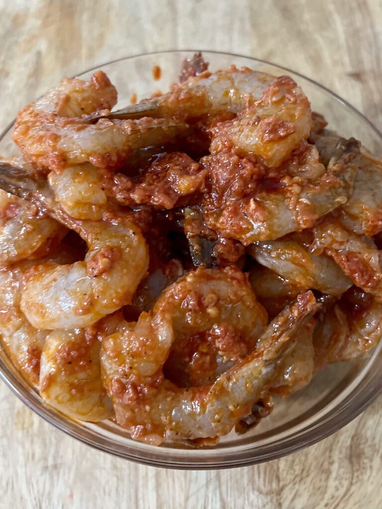 Bowl of marinated shrimp for shrimp fra diavolo recipe.