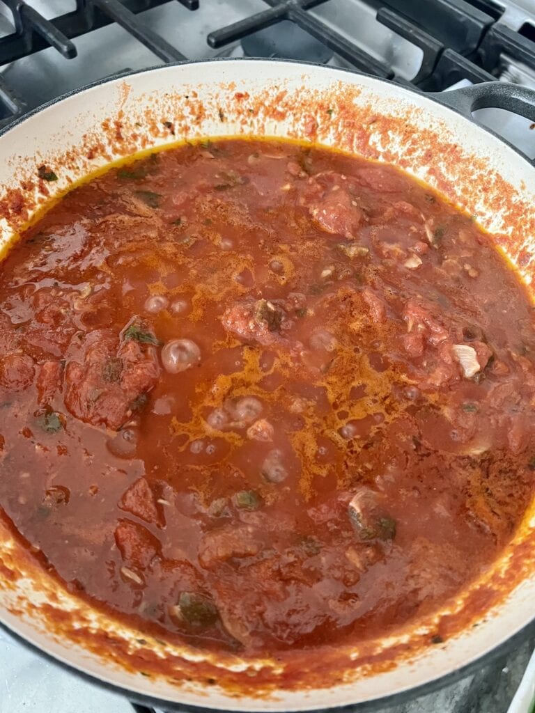 Spicy shrimp marinara sauce simmering in pan.