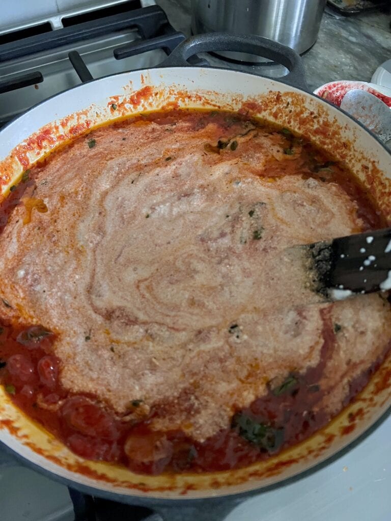 Ricotta cheese mixed into tomato sauce after it's been simmering awhile.
