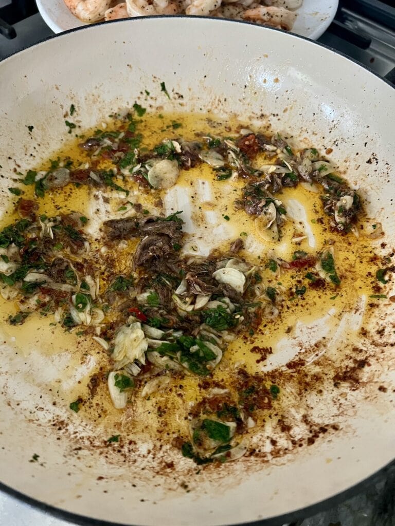 Cooked aromatics in pan, ready for tomatoes to be added.