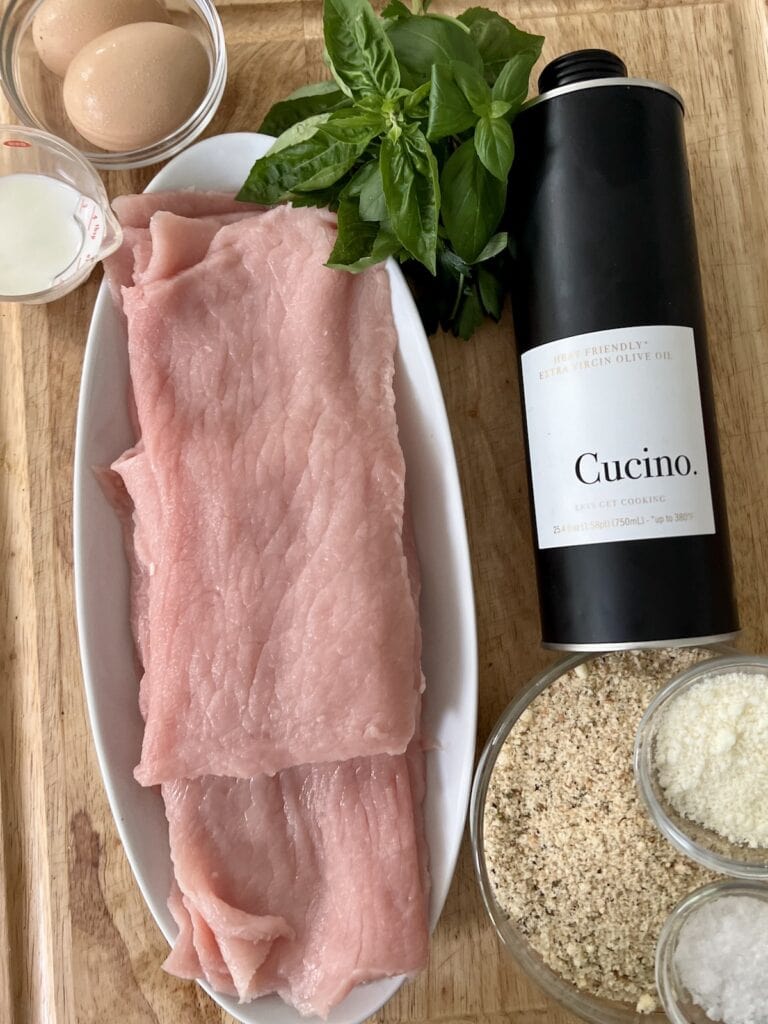 All ingredients for crispy pork cutlets on cutting board.