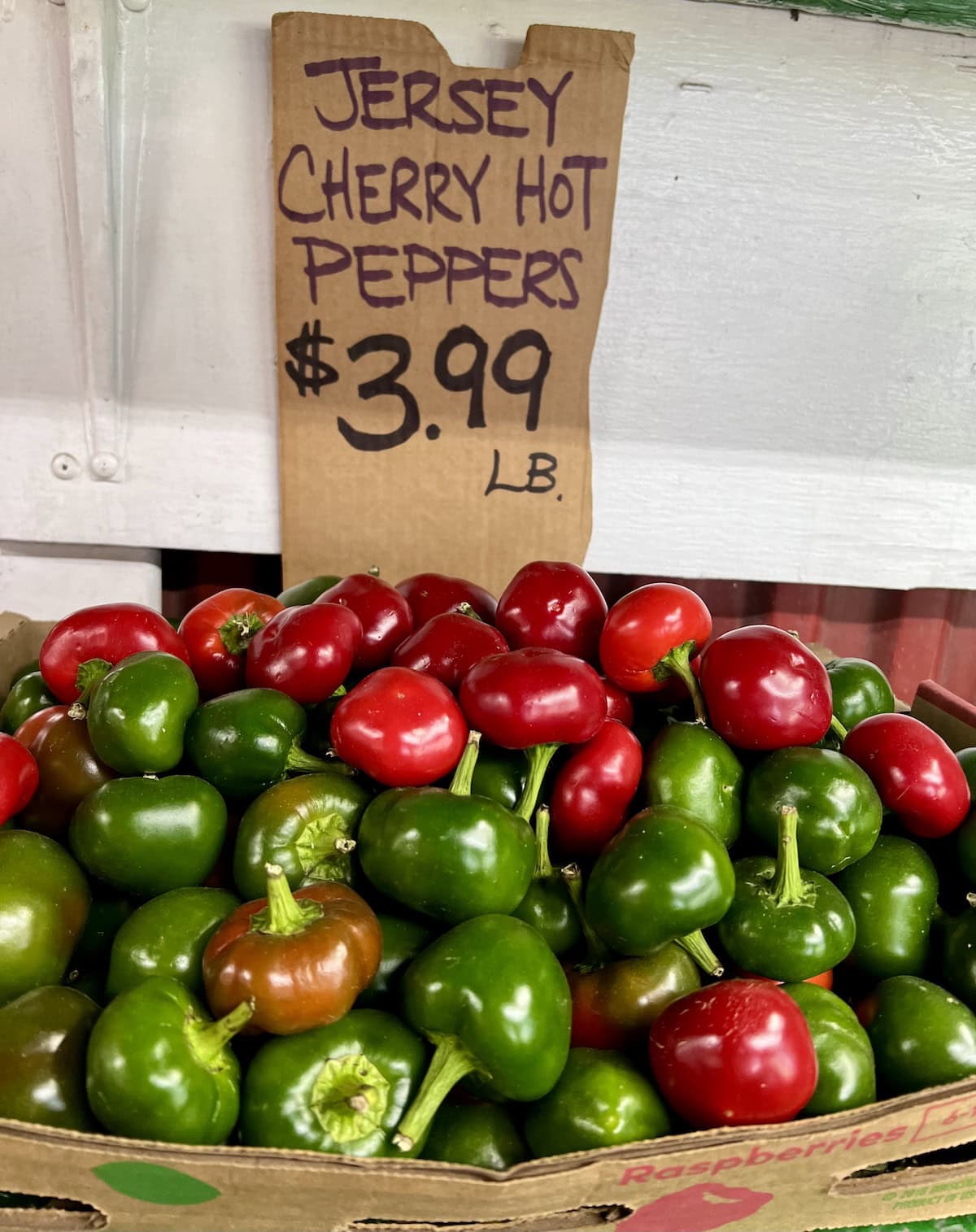 A huge display of hot cherry peppers for display at a local farm stand.