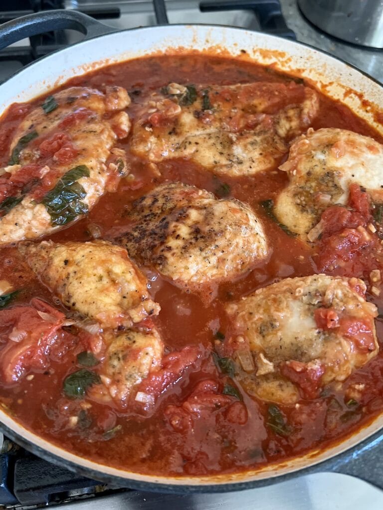 Chicken with Tomatoes simmering in tomato sauce.