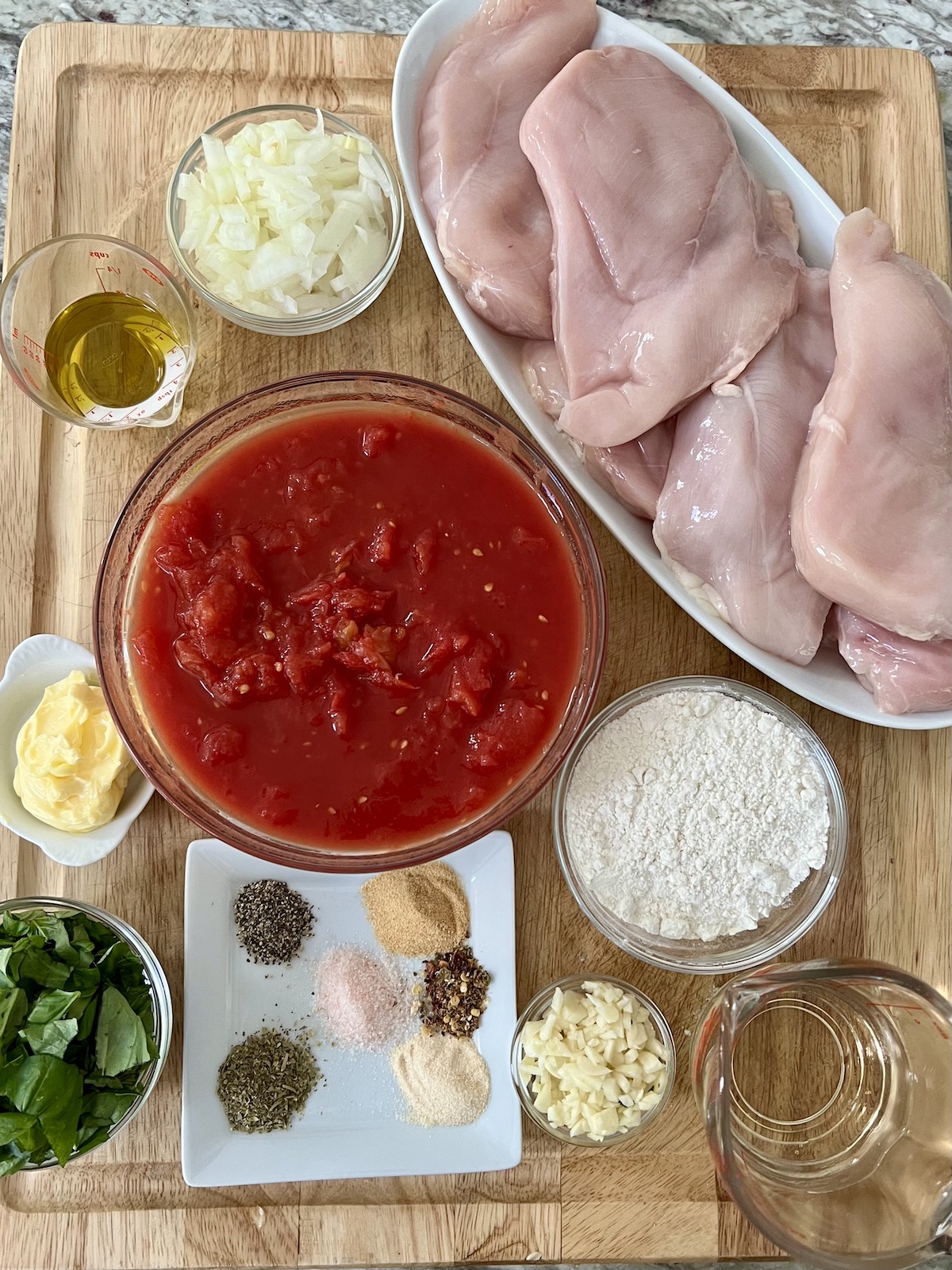 All prepped ingredients for One Pan Chicken Pomodoro recipe on cutting board.