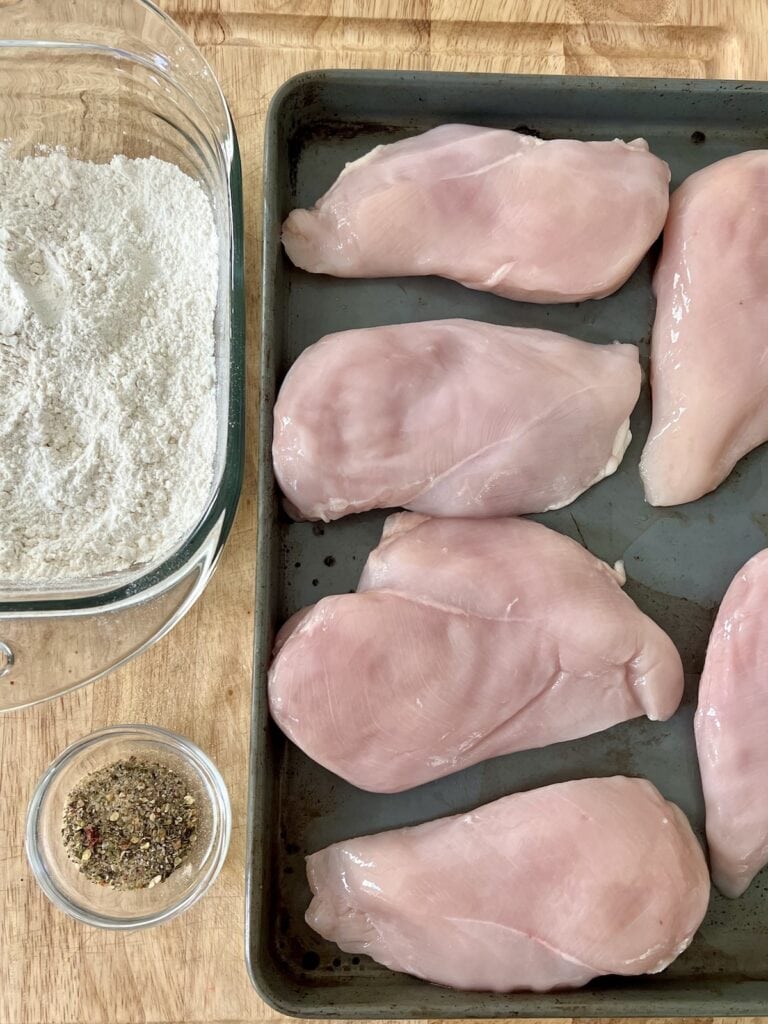 Mise-en-place set up for coating the chicken with sepices and flour.