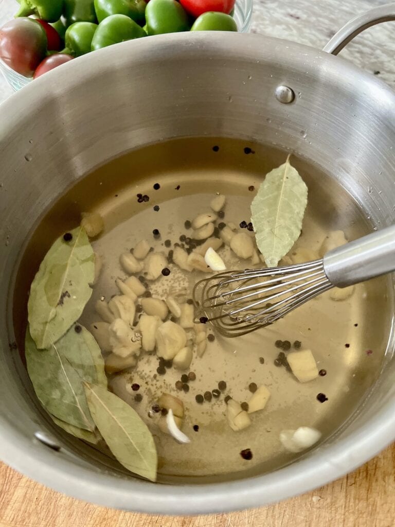 All brine ingredients in pot with whisk read to be heated.