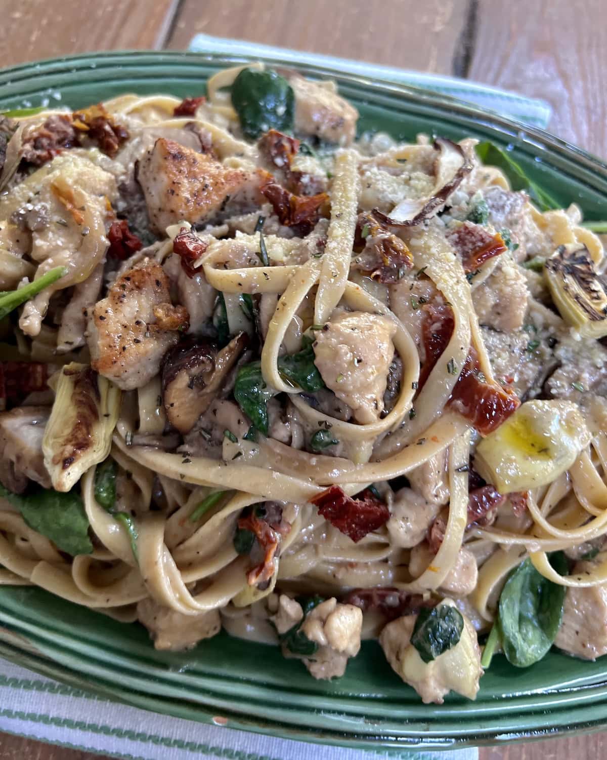 Chicken Marsala Fettuccine in green serving platter.