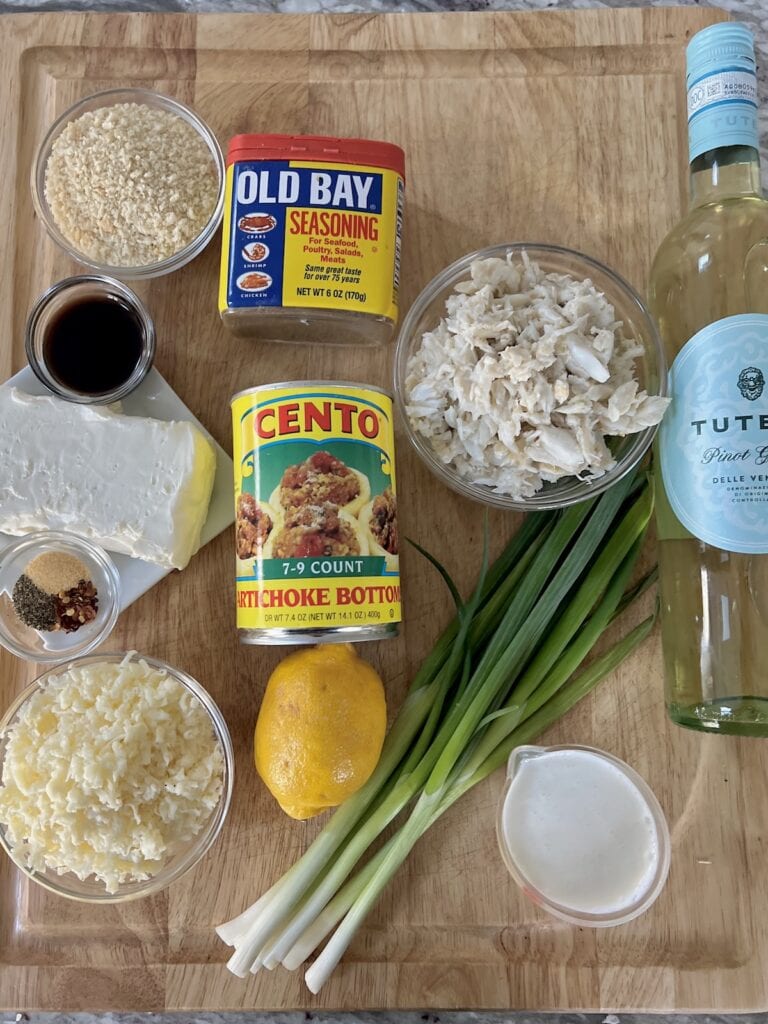 Ingredients for crab-stuffed artichoke bottoms on cutting board.