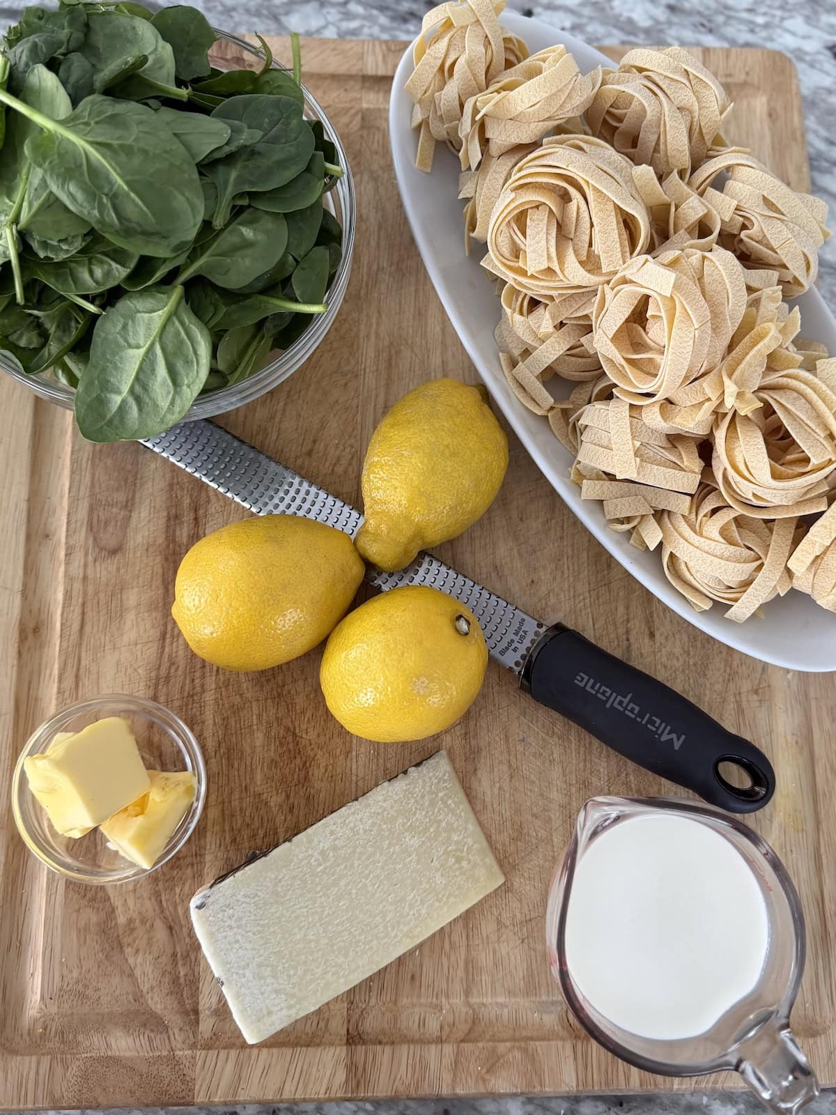 Ingredients for lemon tagliatelle on cutting board.