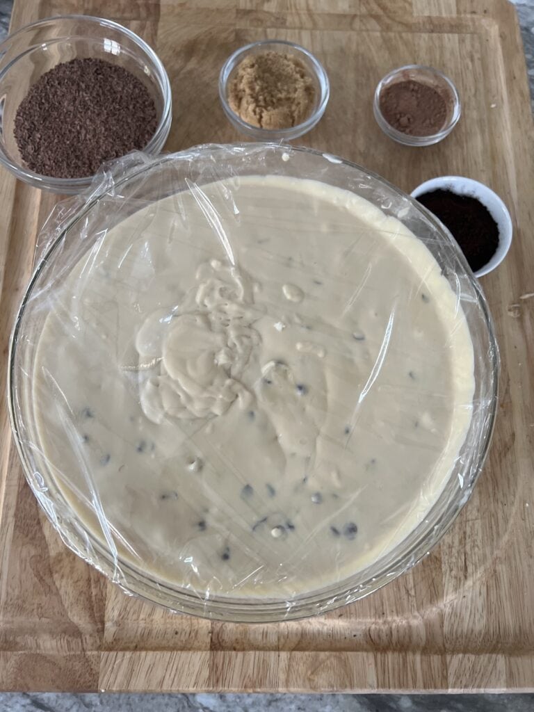 All the prepped components of Italian tiramisu in glass bowls on cutting board.