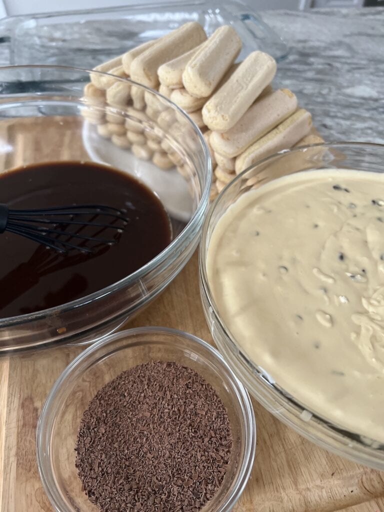 Components of tiramisu classico in glass bowl ready to be layeredready to be layered