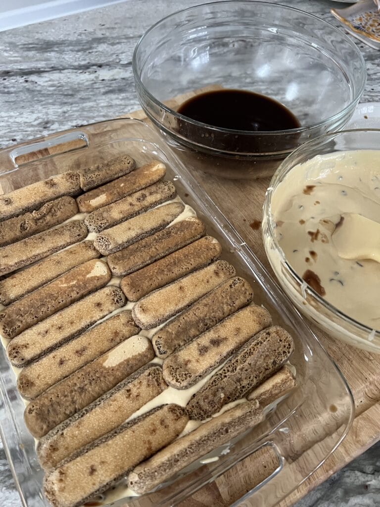 Next layer of ladyfingers laid on top of the cream. 