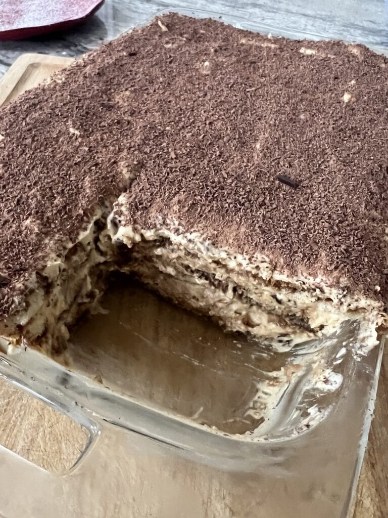 The finished Classic Italian Tiramisu with one slice cut out.