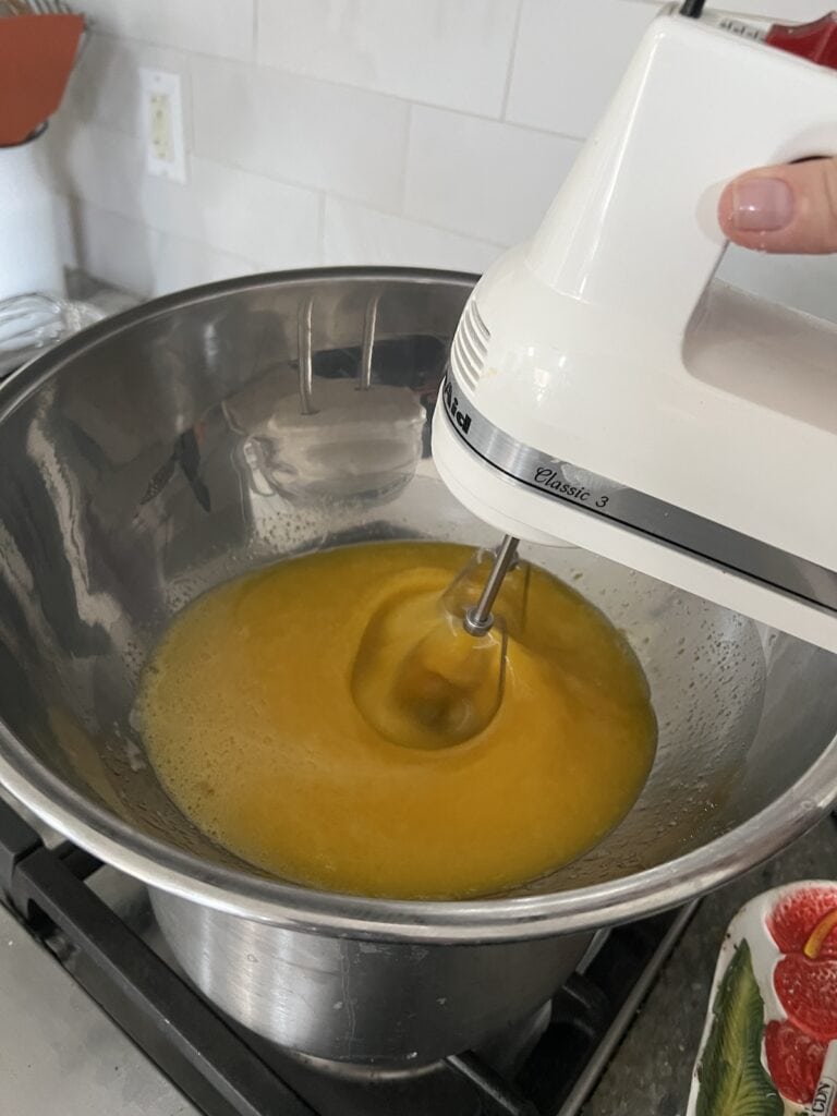 Using hand mixer to make the zabaglione cream for Authentic Italian Tiramisu Recipe.