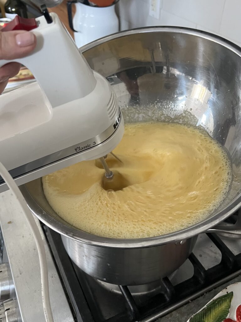 Using hand mixer to make the zabaglione custard.