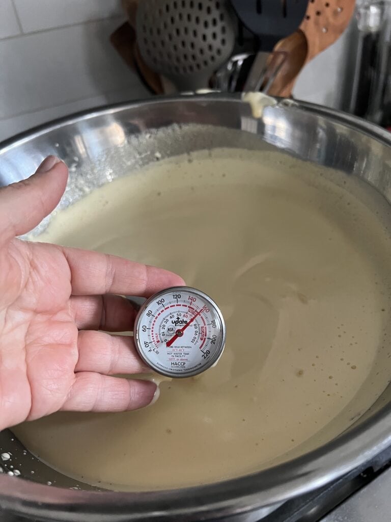 Using a stem thermometer to test the temperature of the vanilla cream for the italian tiramisu.