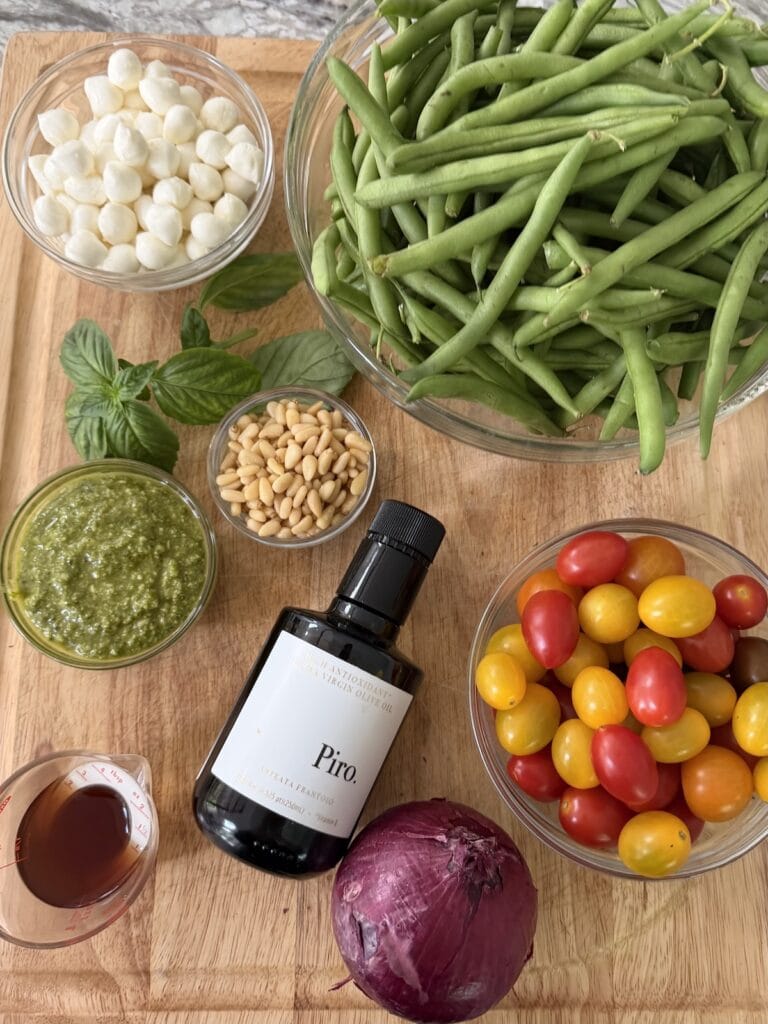 All ingredients for Pesto Green Bean Salad on cutting board.
